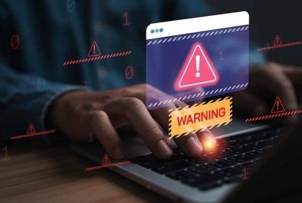 Cybersecurity warning and data protection concept with alert notification on laptop screen, representing cyber attack, online threat, malware detection, system security and network risk management